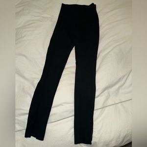 Black leggings with zippers on the bottom of the leg.